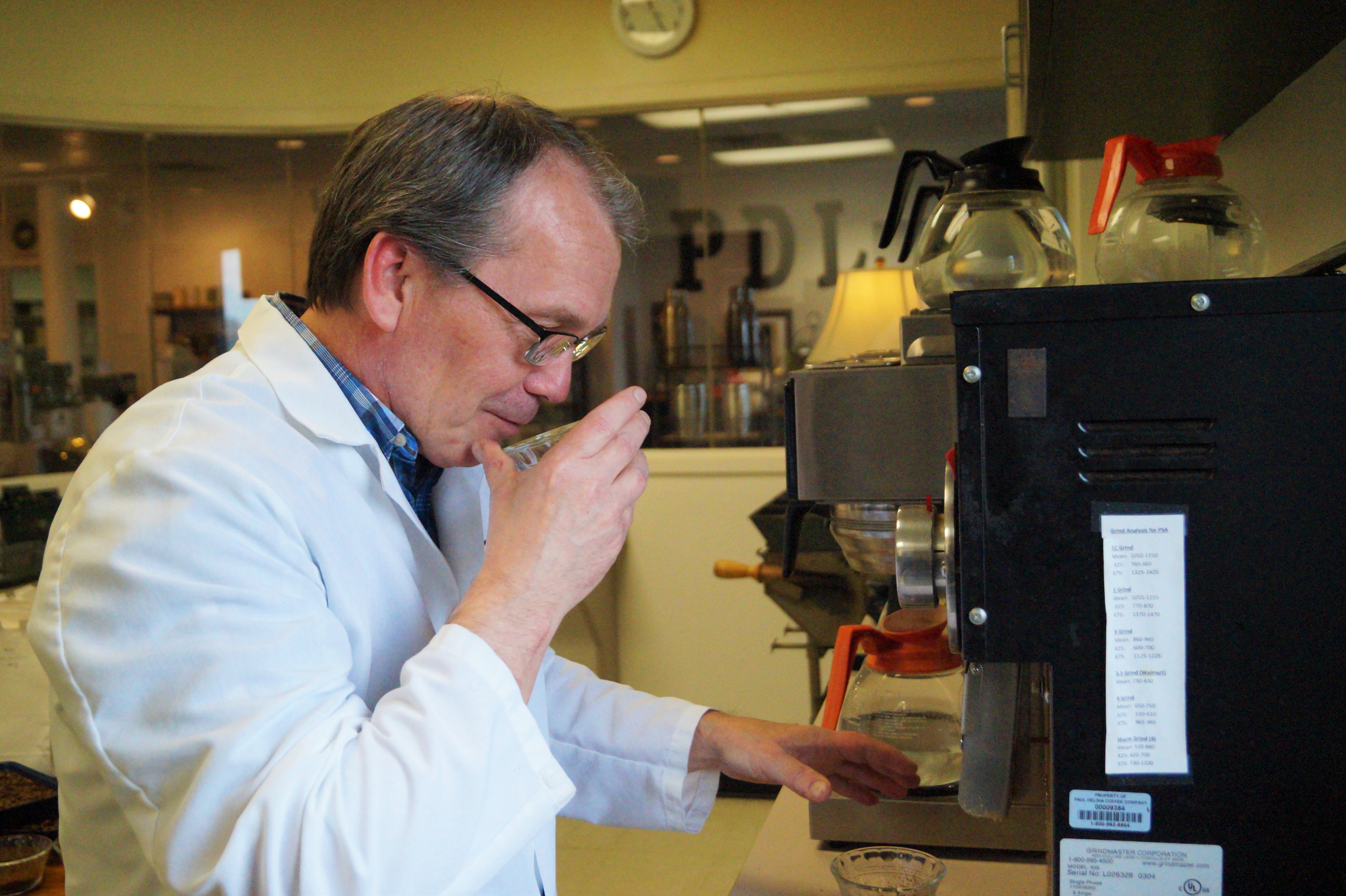 Glenn tests how the coffee beans smell in preparation for the cupping process.