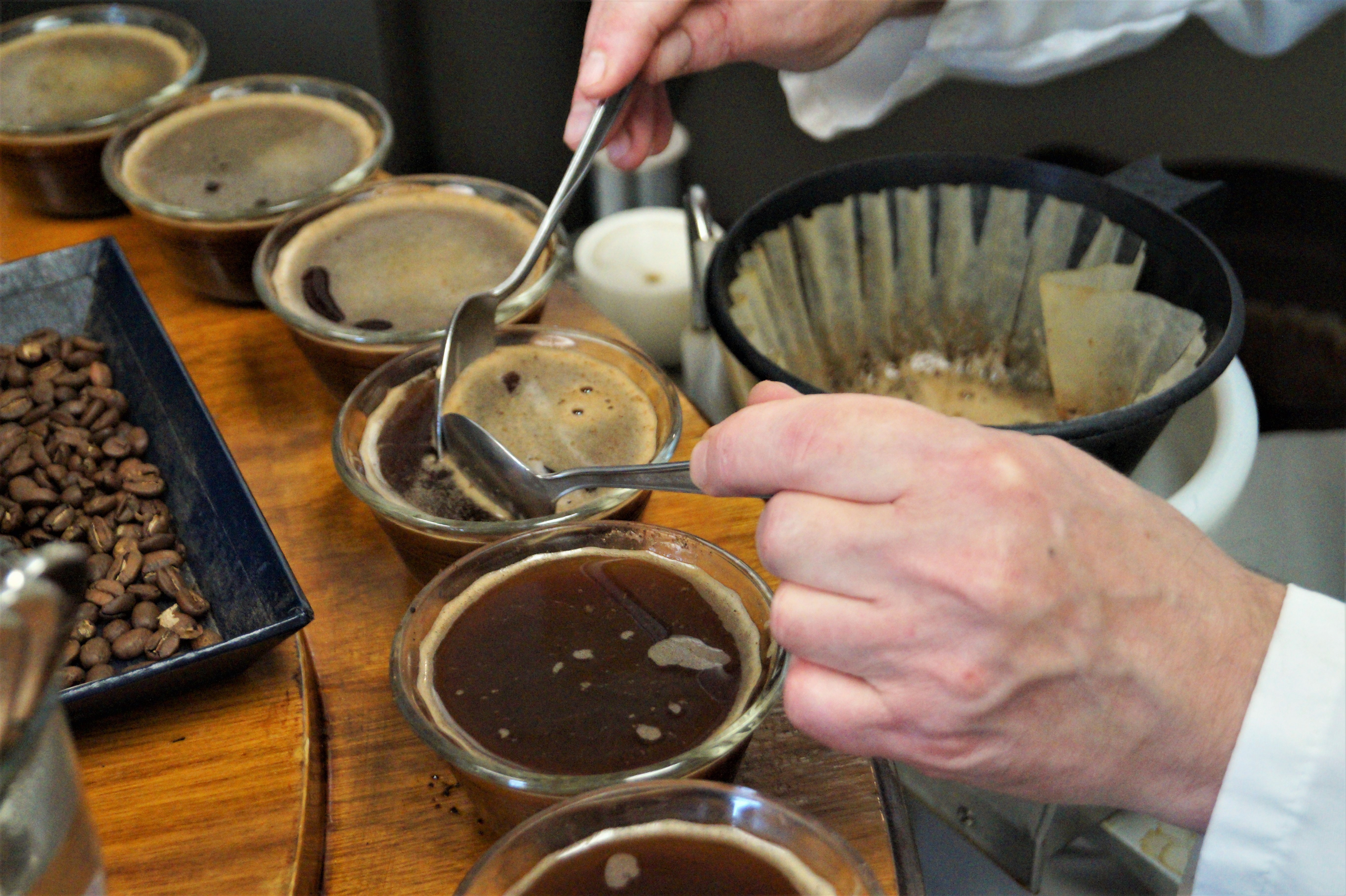 The creme of the coffee is removed after the crust has been broken and before tasting occurs at Paul deLima.