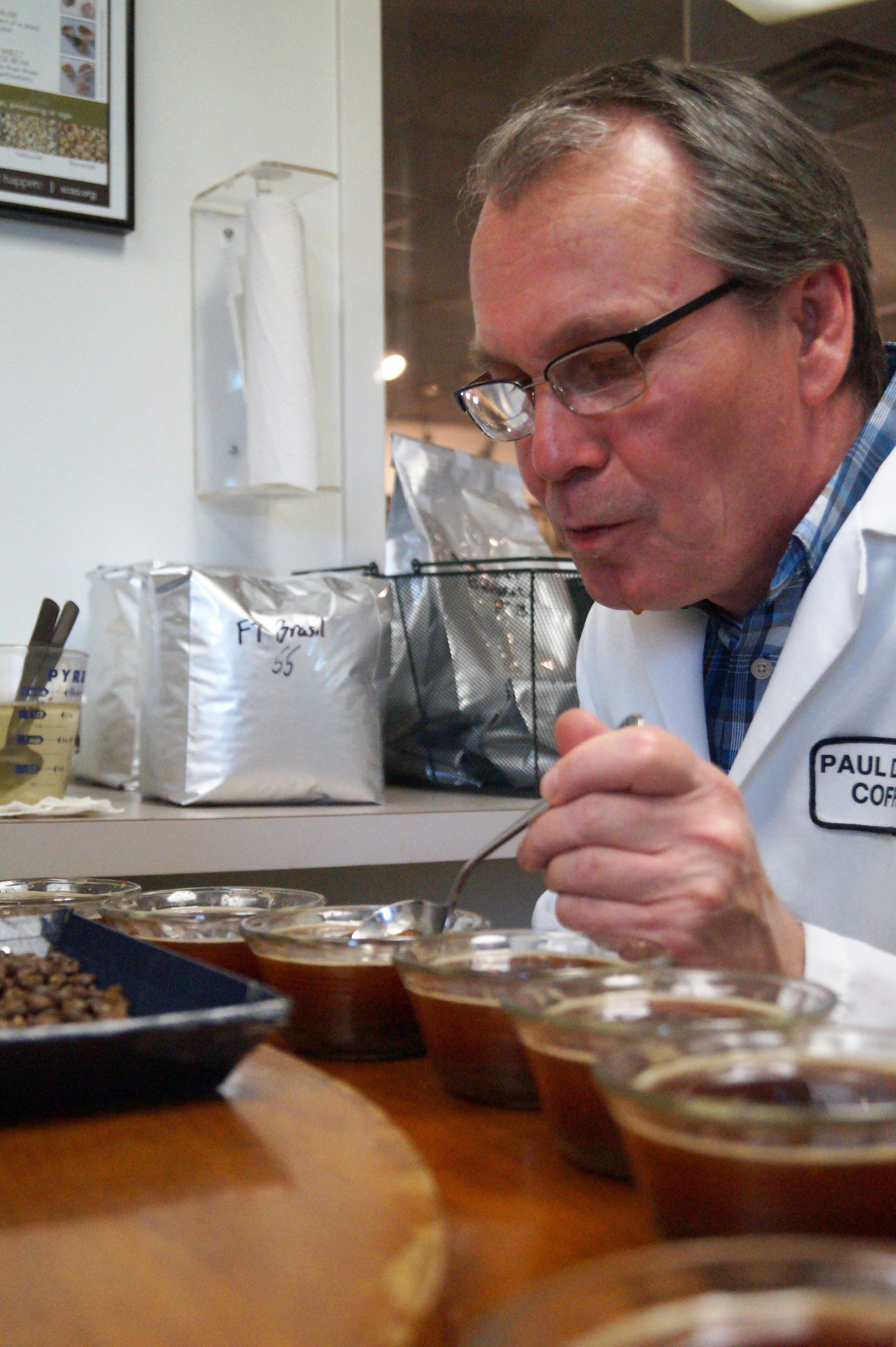 Glenn moving to a new coffee to try at Paul deLima during the cupping process.